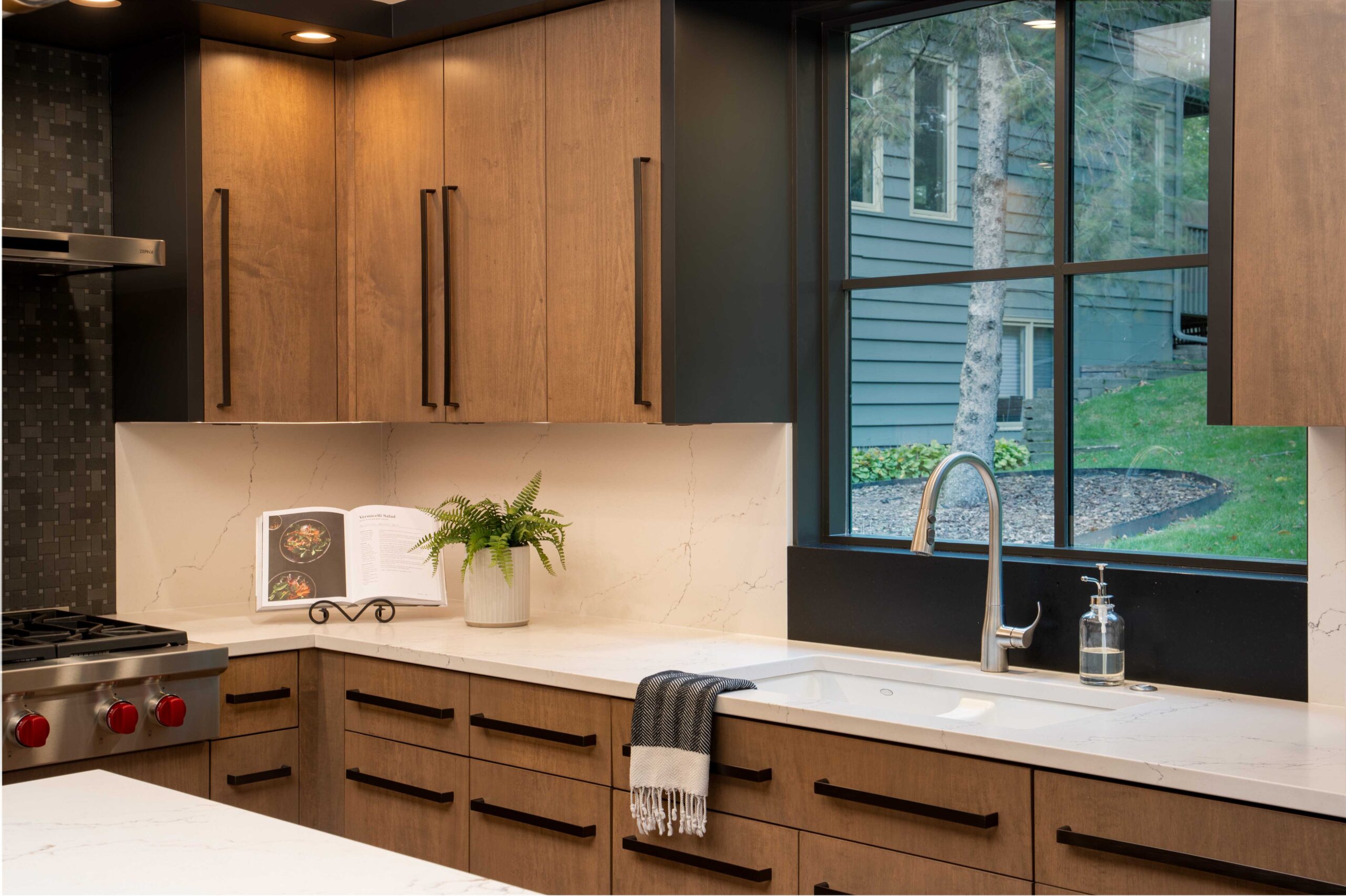 A modern Bloomington kitchen remodel with black cabinets and a window.