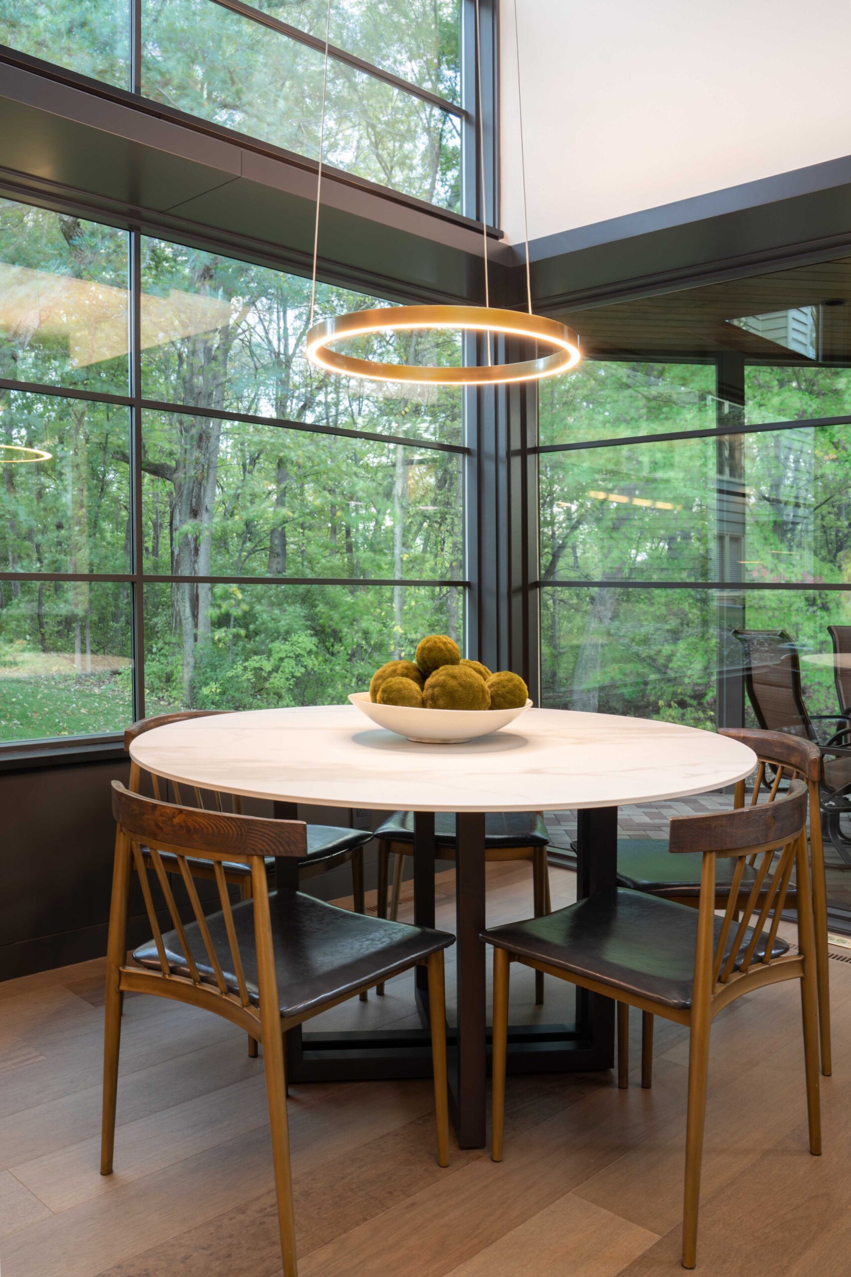 A modern dining room with a large table and chairs in a Bloomington remodel.