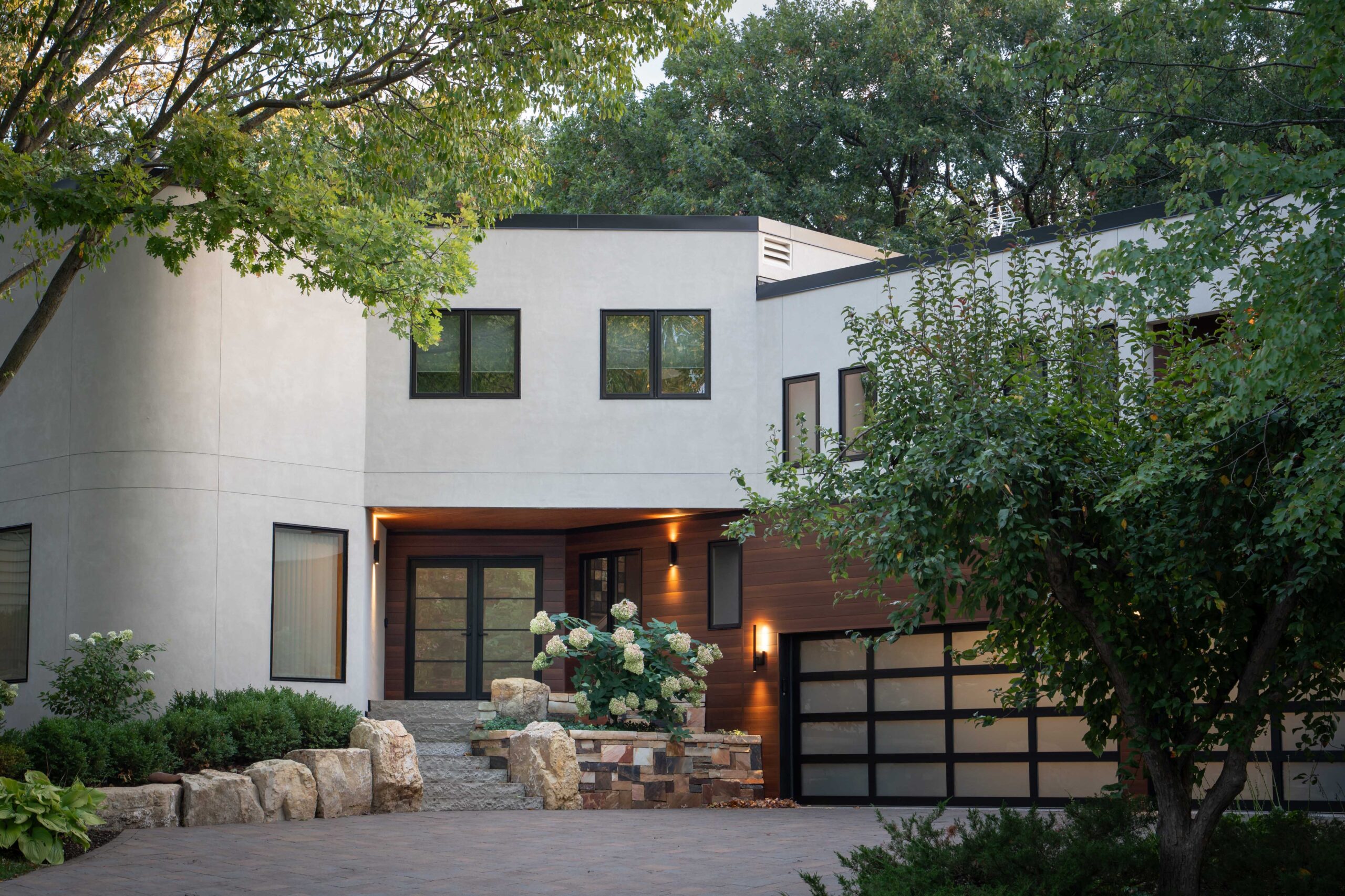 A modern home with a driveway and trees underwent a Bloomington remodel.