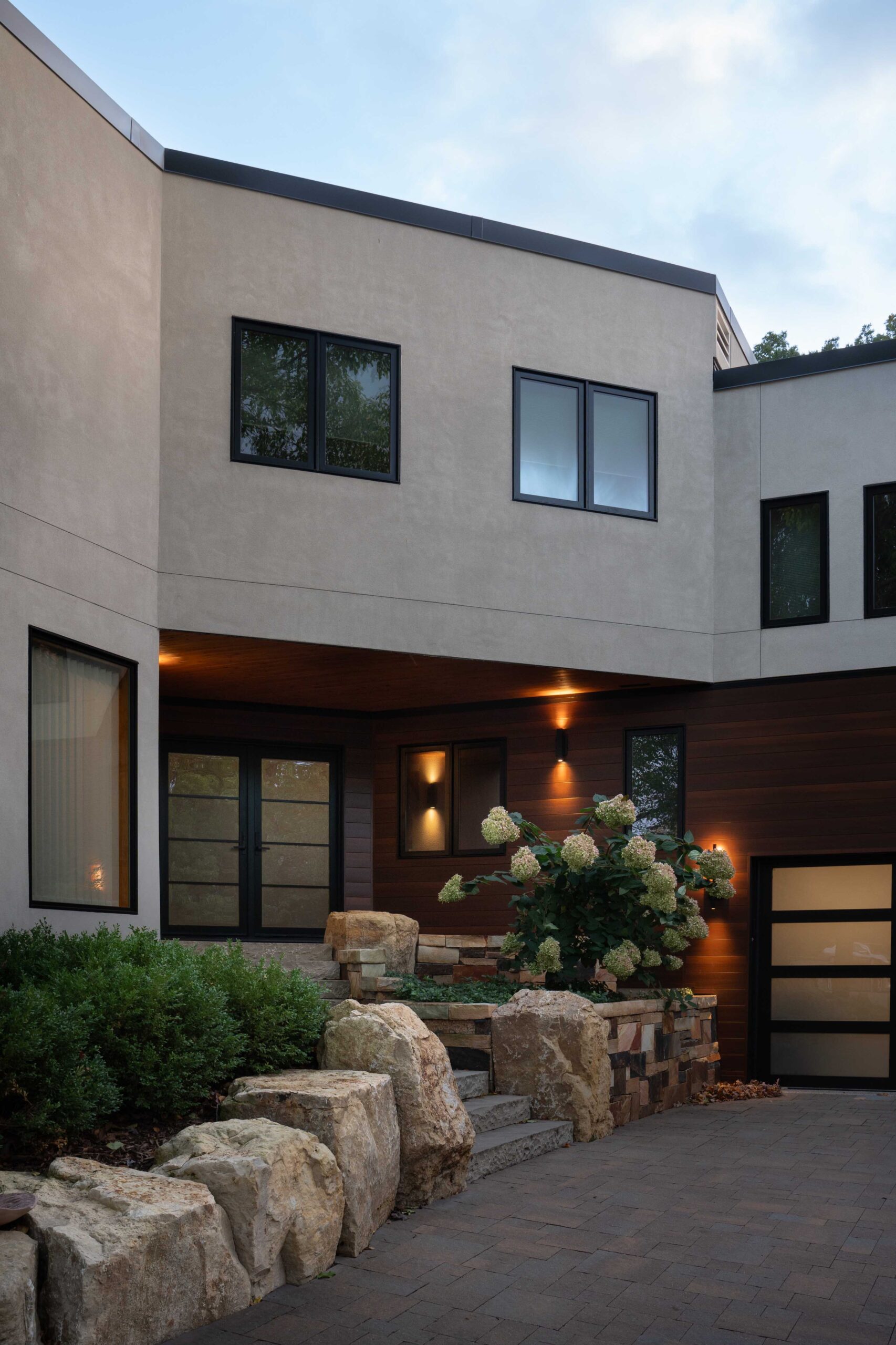 A modern home with a stone driveway and garage in Bloomington.
