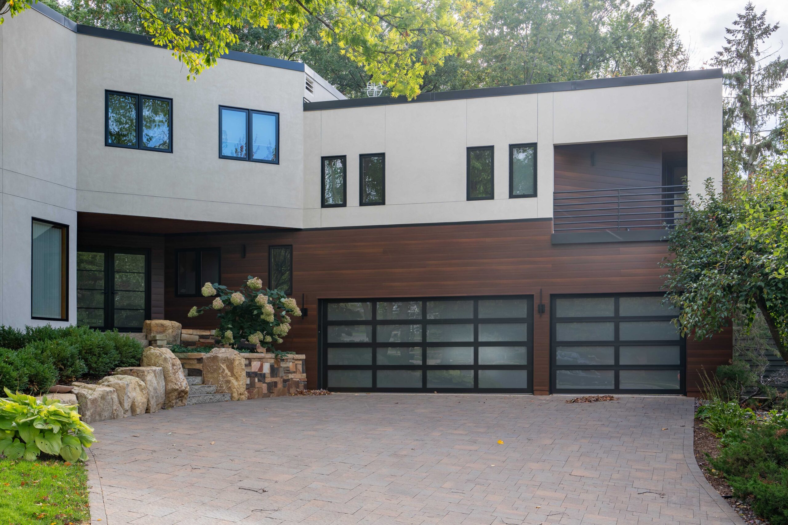 A modern home in Bloomington with two garages and a driveway.