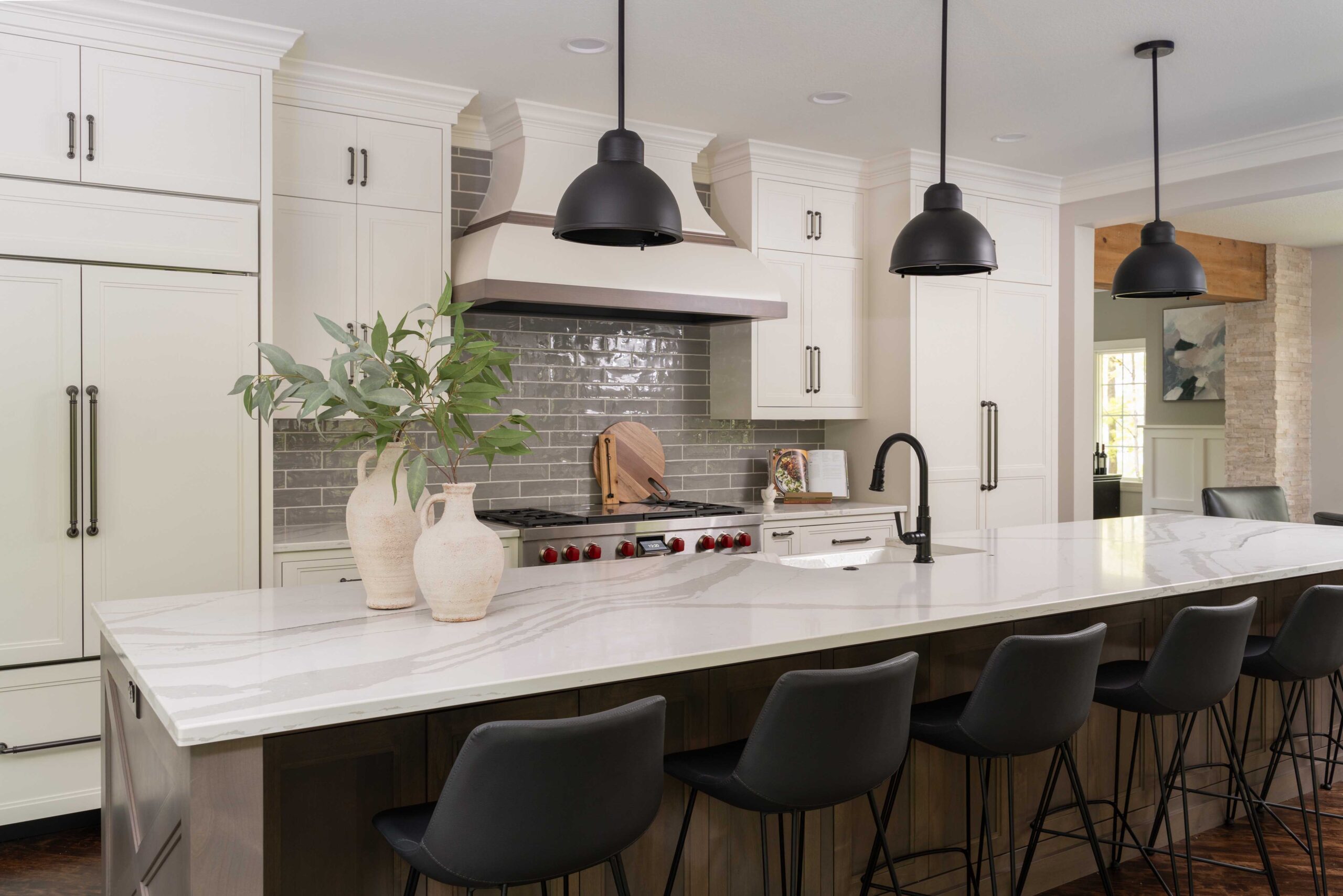 A Great Waters Alcove kitchen remodel featuring a center island and black stools.
