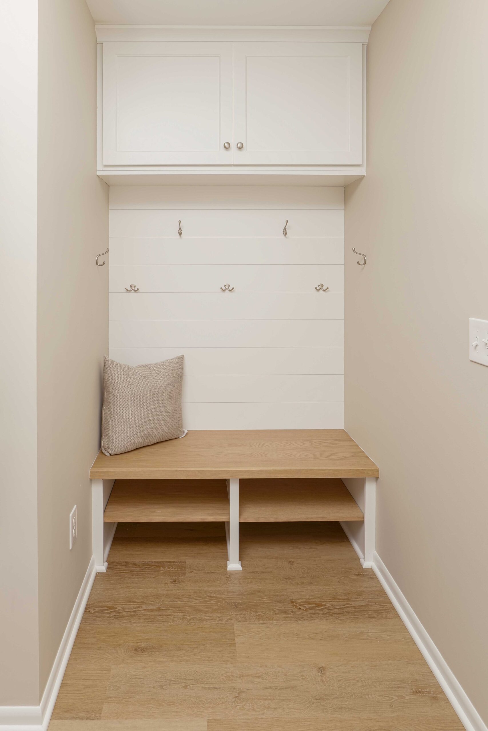 A coastal style mudroom with a bench and storage.