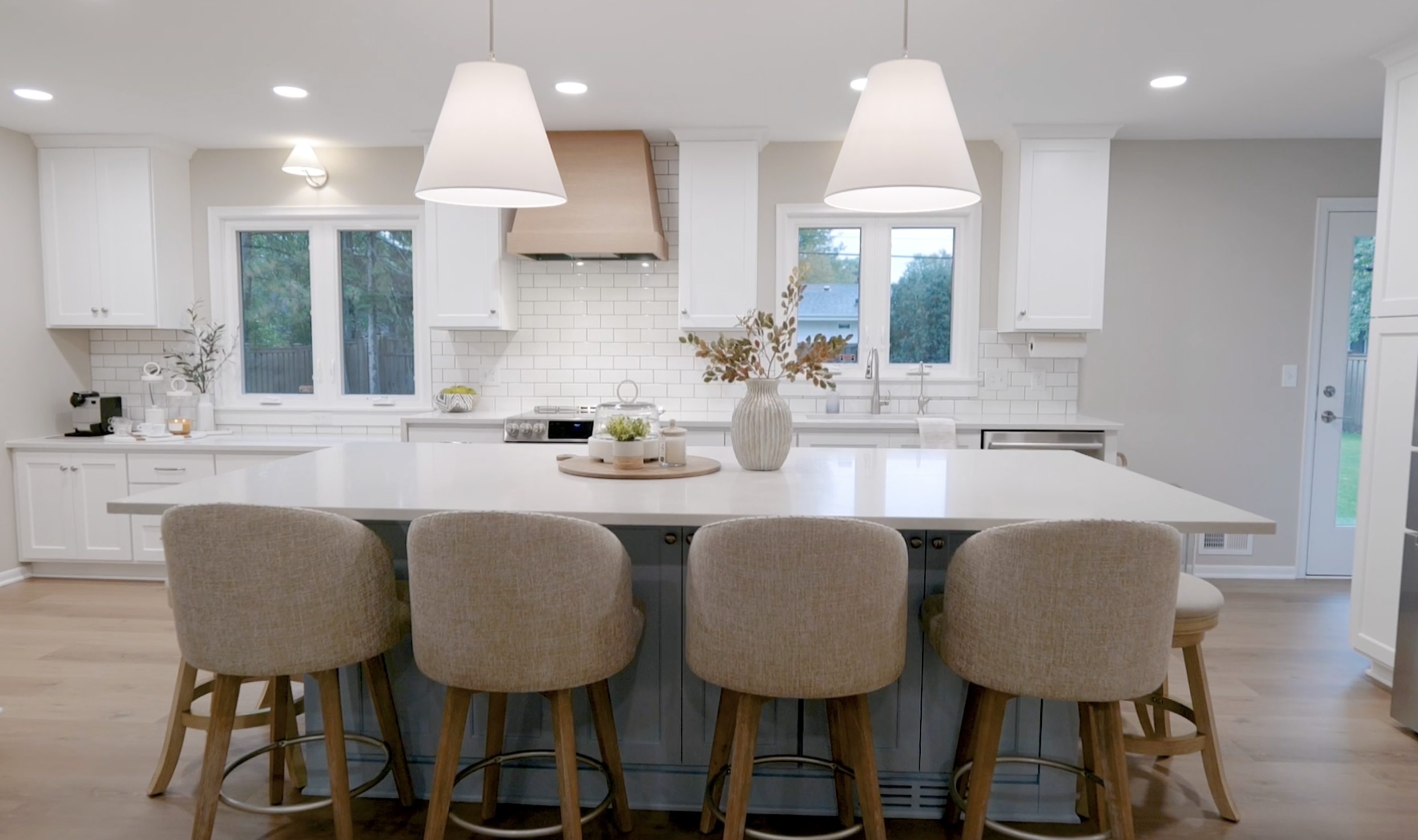 Coastal style kitchen interior with a central island and bar stools.